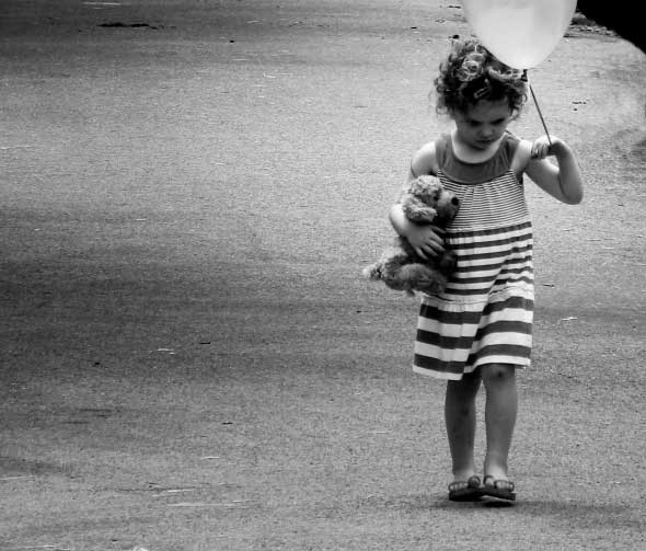 3-year-old girl walking very sad, all by herself